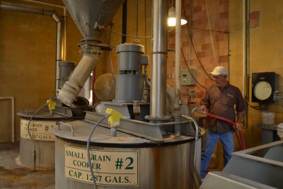Man cleaning small grain cooker at Buffalo Trace Distillery